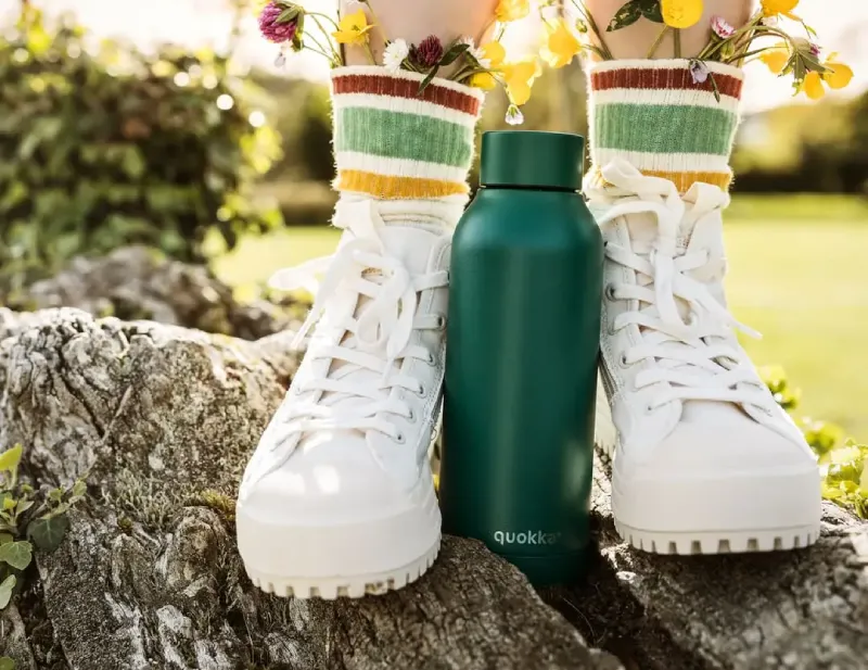 Girl with waterbottle at her feet
